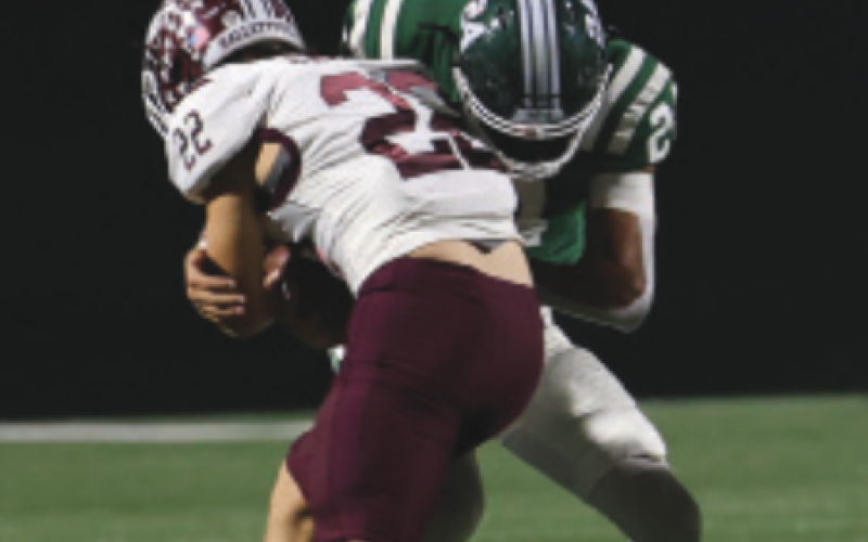 Jesse Cavazos (22) is tackled by Franklin’s Josh Lopez. Chuck Grafe/ Tribune-Herald