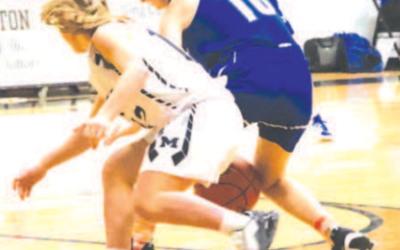 Madelyn Kurtz (10) fights for a loose ball against Moulton Saturday. Chuck Grafe/ Tribune-Herald