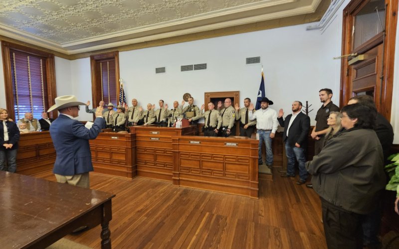 Sheriff Greenwell administers the oath of to his deputies and members of his communications staff, pictured here to right of the photo. Photo by Bobby Horecka