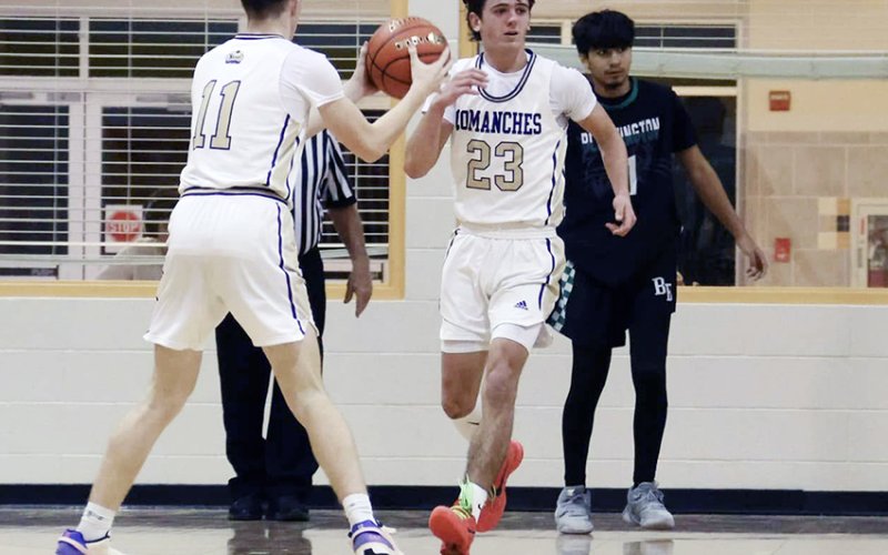 Landen Christensen and Carson Schuette exchange the ball.  Photo courtesy of Louann Heinsohn