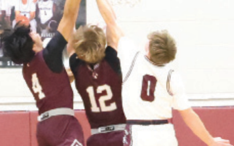 Jack Amsden (0) fights for a rebound vs. Industrial. Chuck Grafe/Tribune-Herald