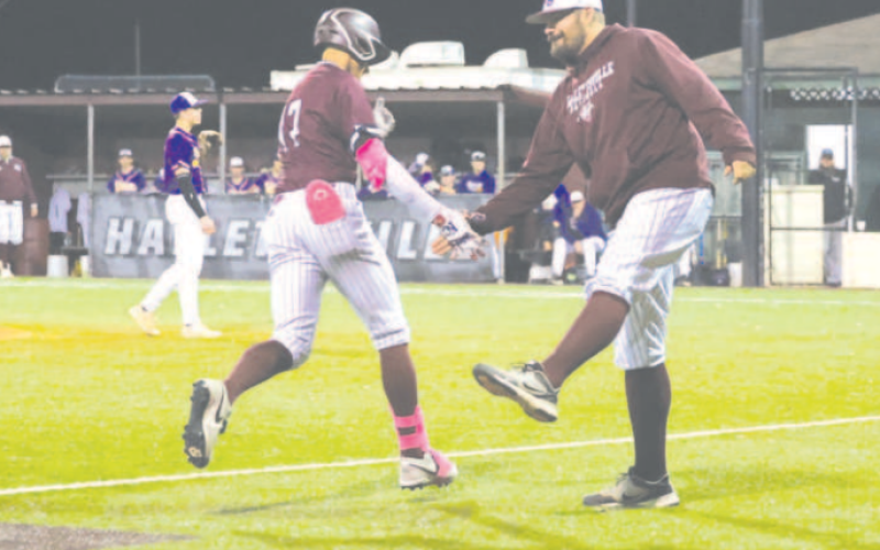 Tanner Wagner is congratulated by coach Brad Gohlke after his three-run homer Saturday night against Shiner. Tanner ended up with seven RBI on the night. Chuck Grafe/Tribune-Herald