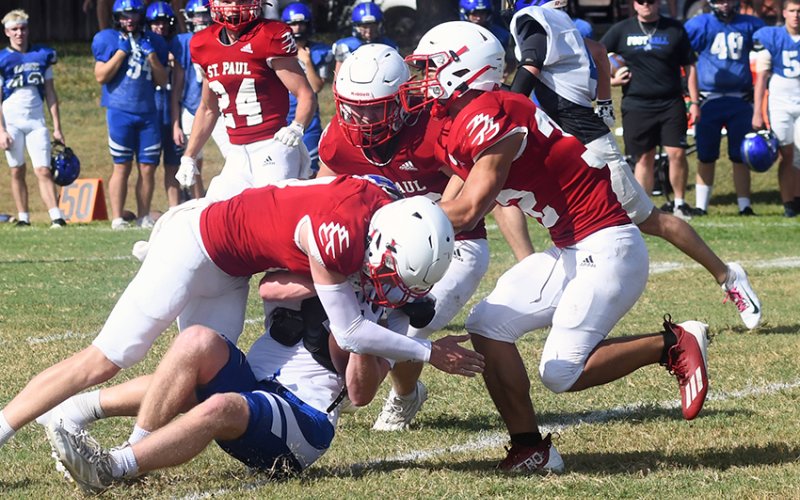 St. Paul defenders bring down a Falcon ball carrier on Friday. Photo by Mark Lube.