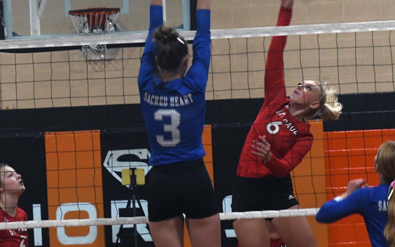 St. Paul’s Emery Kennedy tries to get a hit past Sacred Heart’s Layne Besetzny Friday during the Schulenburg Tournament. Photo by Mark Lube.