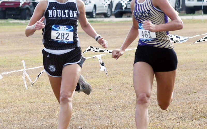Addison Tudyk (right), running with Moulton’s Mina Tinajero, was third overall with a time of  13:20.83. Photo by Mark Lube.