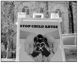 Photo by Hans Lammeman A sign from Golden Crescent CASA outside the Lavaca County Courthouse displays the information for the Texas Abuse Hotline.