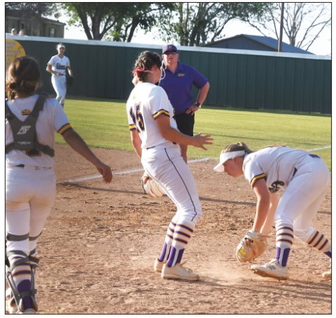 Lady Comanche first baseman Dyllan Chrismon catches the ball with pitcher Paeden Vincik (middle) and catcher Teresa Olivas providing backup. Photo by Mark Lube.
