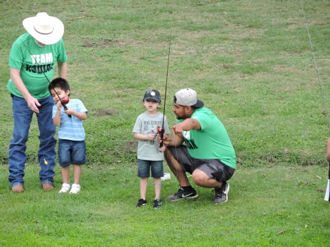 Kodiak Gas Services representatives assist Parker Perez and Troy Penuelaz at the RISE Reel Fishin event held April 28.