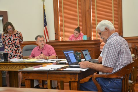  DeWitt County Auditor Carrie Rea and County Judge Daryl inspect budgeted expenditures during a discussion at the July 11 regular meeting. Photo by Hans Lammeman.