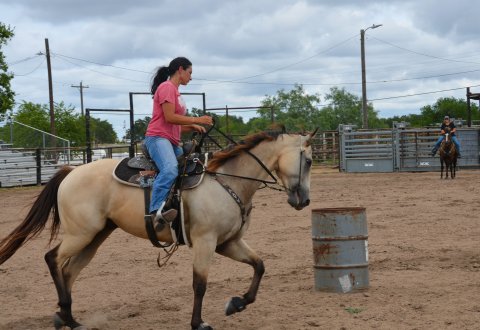 Brittani Richter weaves around barrels at the Yoakum Rodeo Arena Friday, July 15.