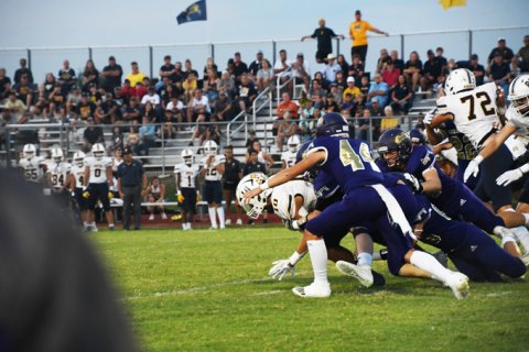 Hunter Knight helps to bring down Poth running back Matthew Bunn. Photo by Mark Lube.