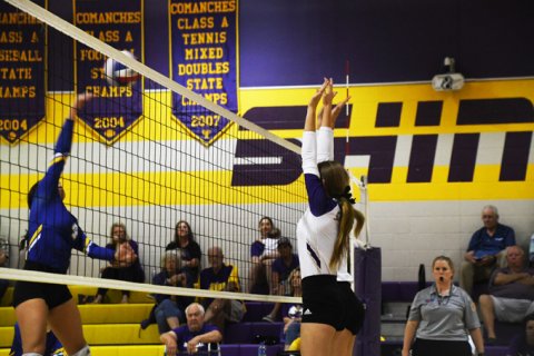 Aimee Mitchon and Avery Boedeker attempt to block a ball at the net. Photo by Mark Lube.