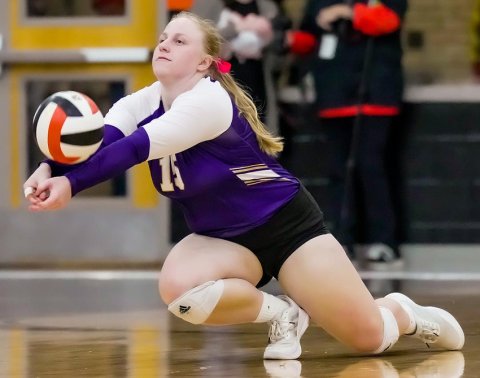 Junior Charlotte Grosenbacher prevents a point with a dig. Photo courtesy of Howard Esse.