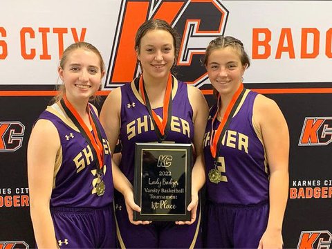 Lady Comanche seniors from left is Megan Winkenwerder, Alyson Mraz and Haley Patek display the KC Tournament trophy. Photo courtesy of Michelle Winkenwerder.