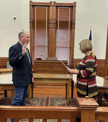 DeWitt County Commissioner Precinct 4 Brian Carson (Left) takes the oath of office administer by County Clerk Natalie Carson in the DeWitt County Courthouse Sunday, Jan. 1. Contributed Photo.