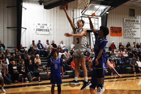 Talan Darilek tries a shot in the first half against Waelder. Photo by Mark Lube.
