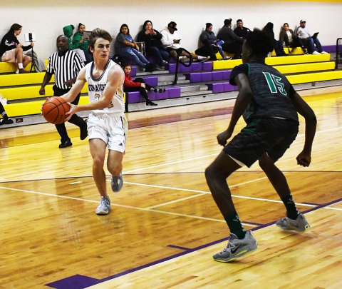 Micah Carson heads for the paint in the second half against Bloomington. Photo by Mark Lube.