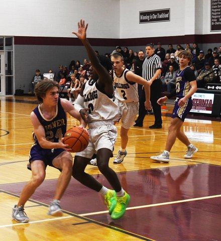 Micah Carson fights his way to the paint against Flatonia. Photo by Mark Lube.
