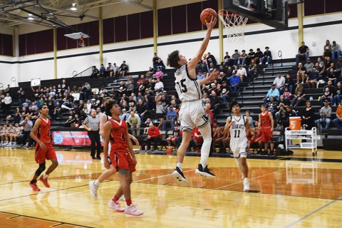 Trenton Meisetschleager attempts a layup. He led the Katz with 23 points. Photo by Mark Lube.