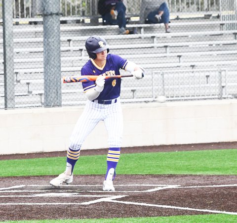 Senior Drew Wenske looks to lay down a bunt during Shiner’s Sacred Heart Tournament game against Brazos Christian. Wenske was named MVP of the tournament. Photo by Mark Lube.