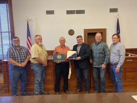At Monday’s Commissioners’ Court meeting, Lavaca County legislature chairman Paul Yamarick presented the court with a Texas flag. The flag flew over the Capitol on Monday, March 13, the day the state legislature held Lavaca County Day at the Capitol. From left are commissioners Dennis W. Kocian, Kenny Siegel, Yamarick, Judge Keith Mudd and commissioners Wayne Faircloth and Edward Pustka. Photo by Jimmy Appelt