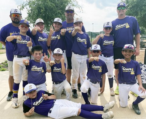 Pictured with their championship rings are front row Garrett Fric (MVP), second row kneeling Kolt Keller, Kannon Keller, Nicholas Villa, Tres Villa, Back Row Coach George Villa, Grayson Neskora, Landen Neskora, Conley Patton, Coach Jason Keller, Killian McDonald, Colby Strezlcyzk and, Coach Greg Strezlczyk. Photo Courtesy of Stephanie Keller.