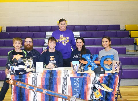 Shiner senior Gavyn Gipson signed with Northland College in Wisconsin to run cross country and will also try his hand or rather his feet at cross-country skiing. Sitting from left is Carter Gipson, Stephen Gipson, Gavyn Gipson, Sheena Gipson and Lilyana Gipson. Standing is head cross-country coach Michelle Winkenwerder. Photo by Mark Lube.