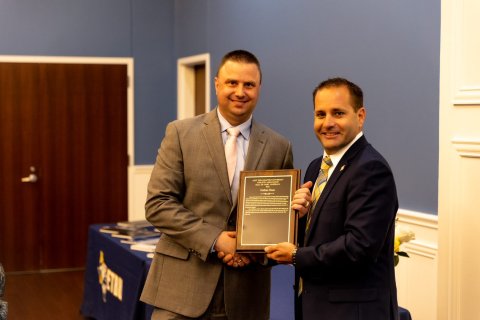 From left is Haas and ETBU Vice President for Student Engagement and Athletics/ Athletic Director, Ryan Erwin, who presented the HOF plaque.