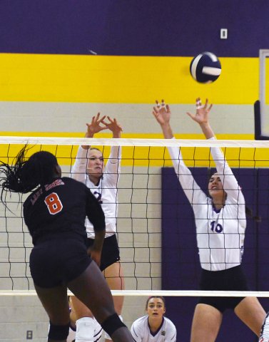 Callie Sevcik (left) and Morgan Lenehan attempt to block a Shorthorn kill attempt. Photo by Mark Lube.