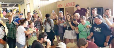 Individuals at Kolache Fest cheer on the kolache eating contest