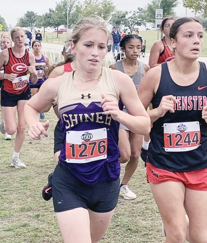Hayleigh Burns passes Lilly Johnson  from Muenster in the Class 2A girls two-mile race at the state cross-country meet on Saturday. Burns set a state meet PR with a time of 13:26.10. Photo courtesy of Michelle Winkenwerder.