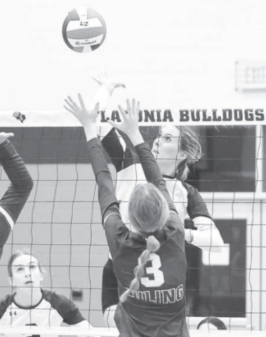 Addison Pekar tips the ball over the net for a point against Luling Lady Eagles.Photo courtesy of Raymond Rosas.