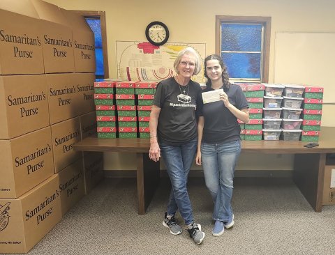 Pictured are Lanelle Amann, left, a member of First Baptist Church who collected the boxes, and Emersen Linn.