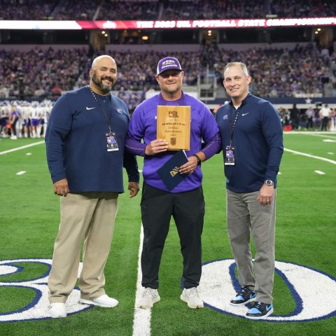 Pictured are Coach Daniel Boedeker, center, with UIL representatives.