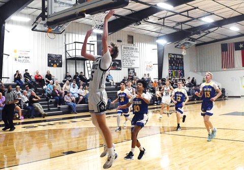 Tyler Siegel goes for a jumper in the first half Friday evening against Bastrop Tribe. He contributed a dozen points in the win. Photo by Mark Lube.