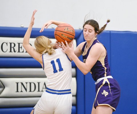 Shiner’s Rylee Vancura (right) tries to fend off Sacred Heart player Addison Ferry Jan. 2 in Hallettsville. Vancura scored six points as Shiner rolled to a 49-8 win. Photo by Chuck Grafe/Hallettsville Tribune-Herald.