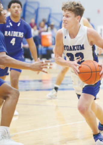Clayton Hlavac (32) moves around a Blue Raider towards the basketball net. Photo courtesy of Raymond Rosas.