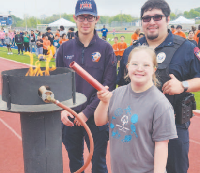 The lighting of the torch during the 2024 DeWitt Lavaca Special Olympics opening ceremony on March 22. Pictured in the front center is student Macy Svec. Pictured in the back row from left to right are Wesley Bordovsky with the Yoakum Fire Department and Mason Galzan with the Yoakum Police Department. Staff photo.