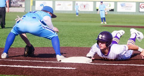 Bode Werner makes a safe return to first base in the Comanches’ win over Sacred Heart on Friday. Photo courtesy of Chuck Grafe/Hallettsville Tribune-Herald.