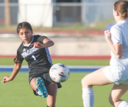 YHS Lady Bulldog Soccer player Makayla Olmedo kicks the ball. Photo courtesy of Raymond Rosas.