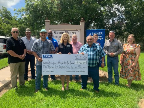 LCRA representatives present a $9,161 grant to the City of Shiner’s Edwin Wolters Memorial Museum to install two mini-split HVAC units and update the building’s wiring.