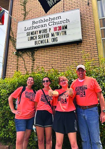 Teena Davis, Emma Davis, Bee Baker, and Pastor Chris Heinold, left to right, pose outside Bethlehem Lutheran Church where they performed volunteer work.