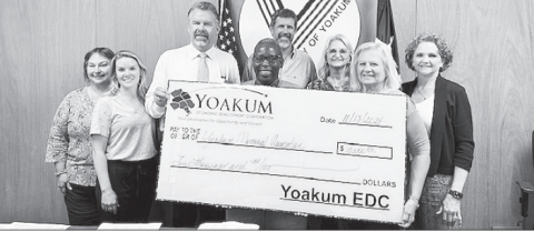 Members of the YEDC board submit a $10,000 check to Vanita Cheeves of the Yoakum Memorial Association. This will go toward new fencing to the Yoakum Colored Cemetery