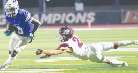 Kennan Dilworth runs past a Trojan defender. Photo courtesy of Raymond Rosas.
