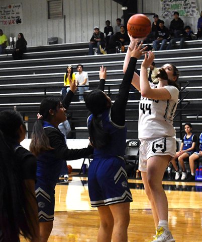 Audrey Swinford takes a jump shot in the first half. Photo by Mark Lube.