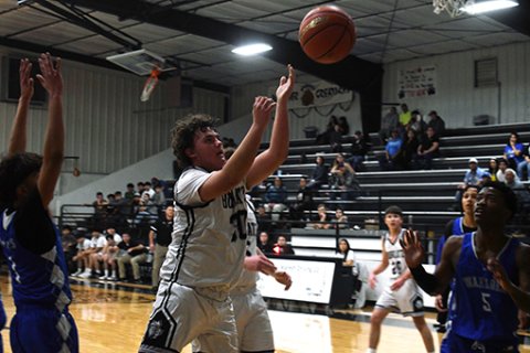 Jaxon Bartos tries an inside shot in the first half. Photo by Mark Lube.