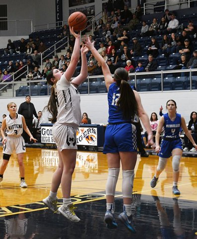Audrey Swinford has a shot nearly blocked by a Cowgirl defender. Photo by Mark Lube.