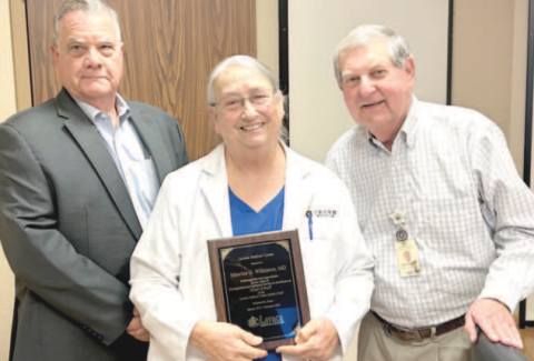At Monday’s Lavaca Hospital District Board of Directors meeting, Lavaca Medical Center physician Dr. Maurice Wilkinson was honored for her many years of dedicated service to the hospital. From left are LHD president James Fenner, Wilkinson, and LMC administrator Steve Bowen. Photo by Jimmy Appelt