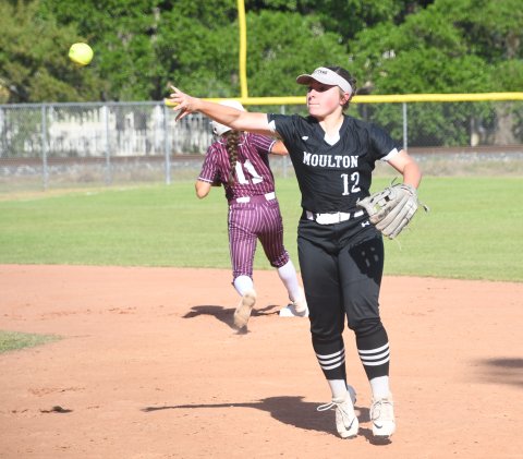 Second baseman Madison Rothbauer makes a throw to first for the third out in the top of the first inning against Ganado. Photo by Mark Lube.