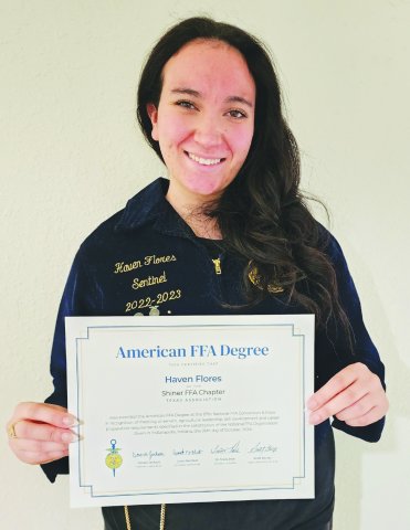 Haven Flores proudly displays her American FFA degree, the highest honor awarded by the National FFA Organization.